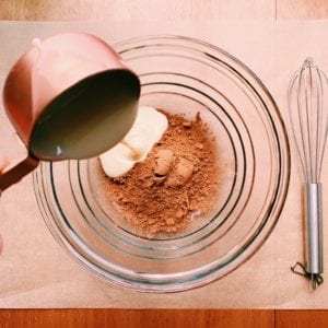 Cocoa and condensed milk being mixed for Neapolitan icebox cake