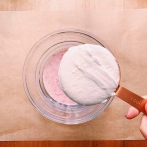 Whipped cream for Neapolitan icebox cake in a measuring cup