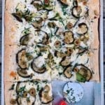 pizza in a sheet pan with eggplant, zucchini and provolone cheese.