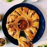 Overhead shot of crescent roll taco ring with salsa