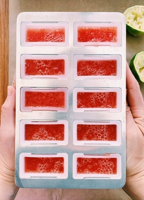 Popsicle mold full of watermelon mint mix ready for the freezer