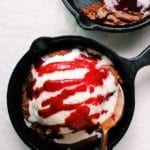 Double chocolate skillet cookie with ice cream and raspberry sauce