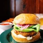 Straight-on view of apricot & curry turkey burger on a brioche bun