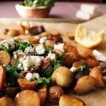 herby potatoes with lemon and feta on a baking sheet