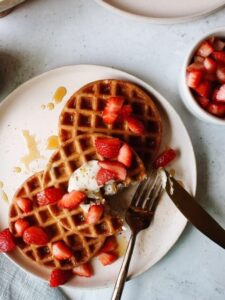 sourdough discard waffles topped with strawberries
