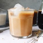 side view of maple oat milk latte in a glass