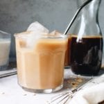 Oat milk latte in a clear glass