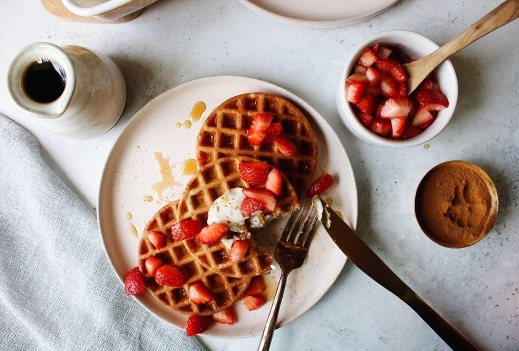 sourdough discard waffles topped with strawberries