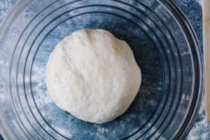 pizza dough in a bowl ready to rise