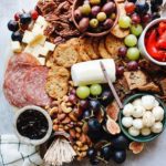 trader joes charcuterie board with meat, cheese, fruit and crackers