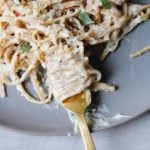close up of fettuccini alfredo made without heavy cream twirled around a fork.