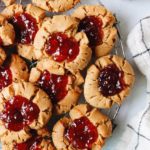 peanut butter and jelly thumbprint cookies on a cooling rack