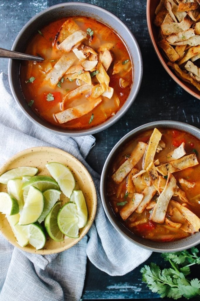 overhead shot of two bowls of healthy chicken tortilla soup