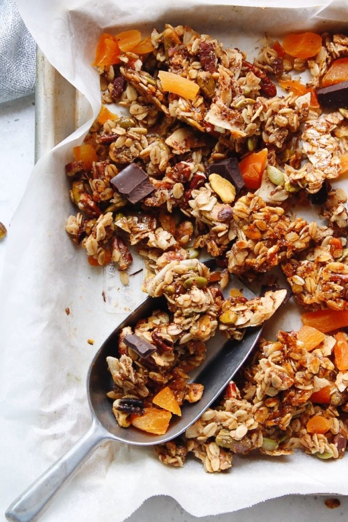 homemade granola on a baking sheet lined with parchment paper