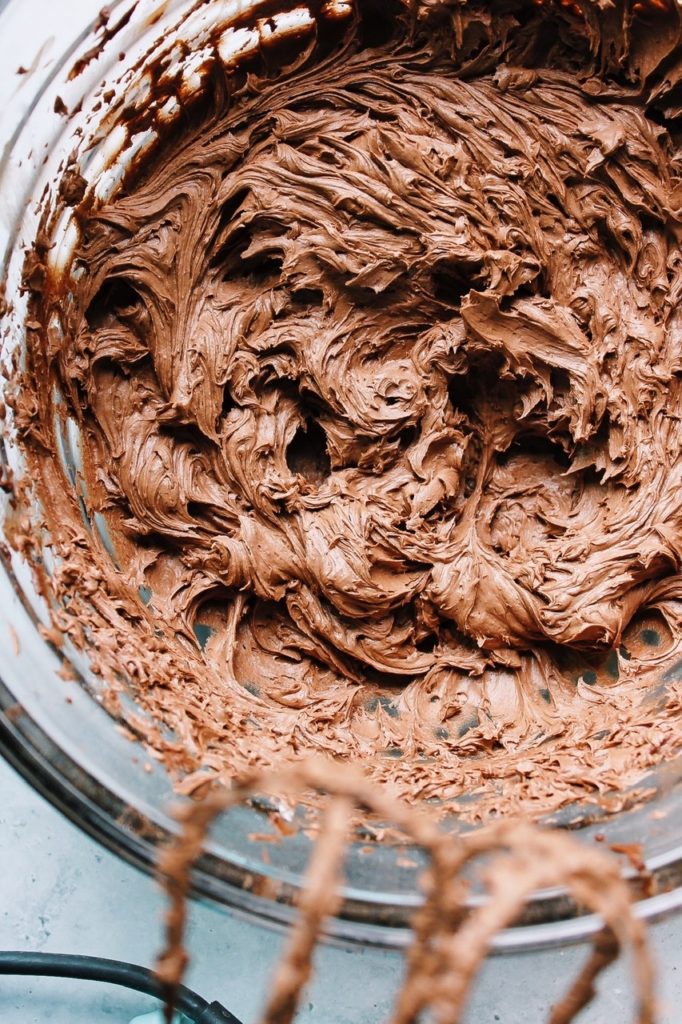 chocolate frosting in a glass bowl