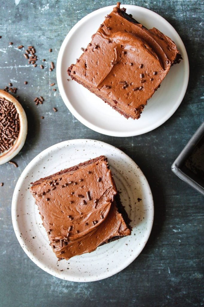 two slices of sourdough chocolate cake on white plates