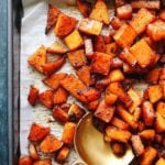 roasted butternut squash seasoned with brown sugar and chili on a sheet pan