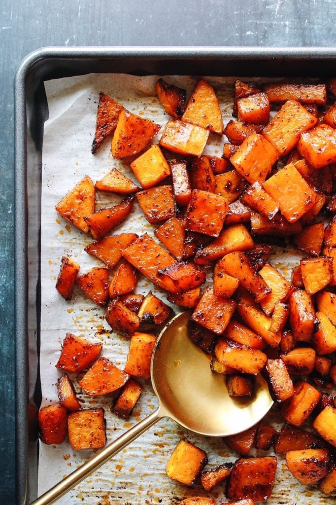 roasted butternut squash seasoned with brown sugar and chili on a sheet pan