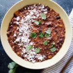 spicy black bean soup topped with cotija and cilantro