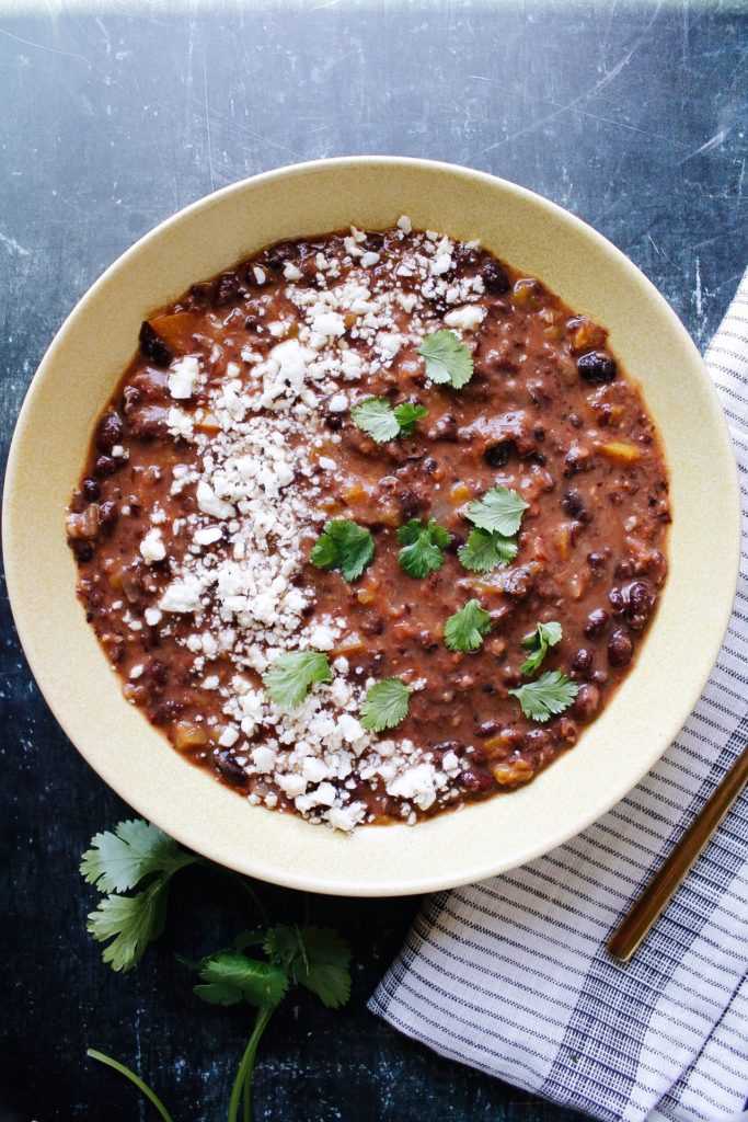 spicy black bean soup topped with cotija and cilantro