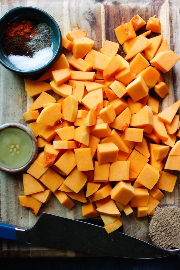 ingredients for sweet and spicy roasted butternut squash laid out on a cutting board