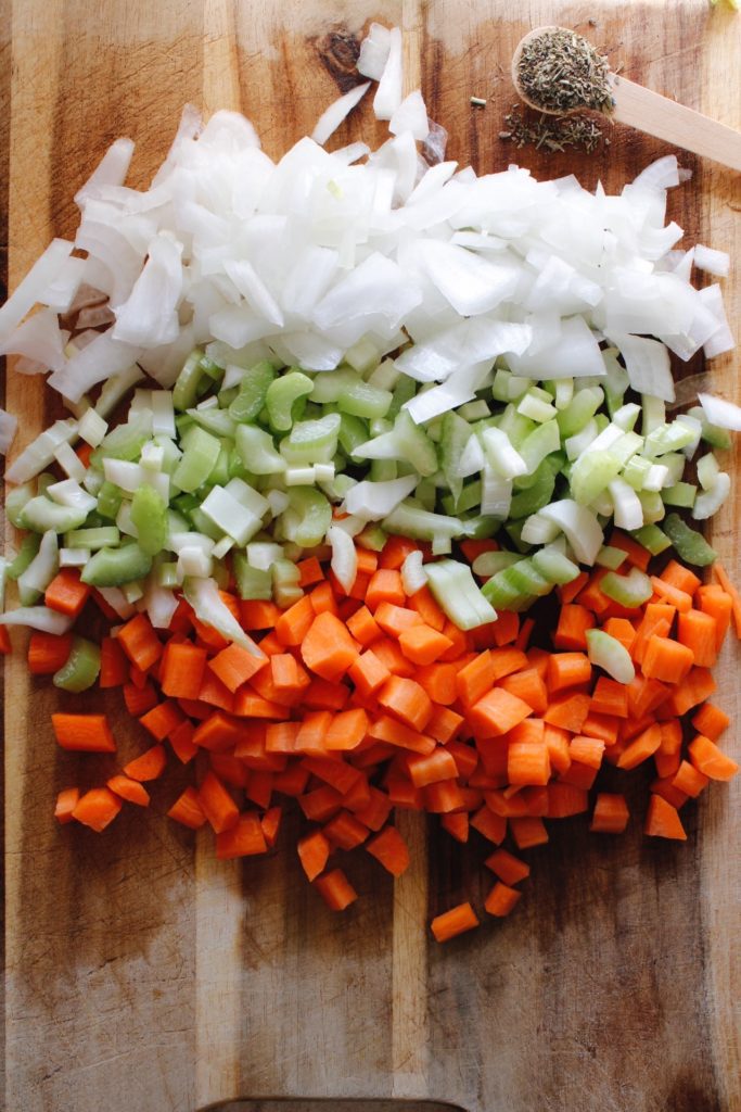ingredients for chicken soup on a cutting board