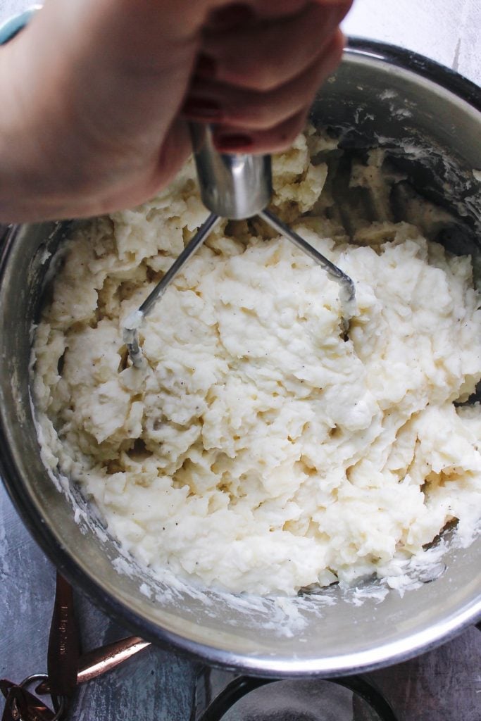 potatoes being mashed