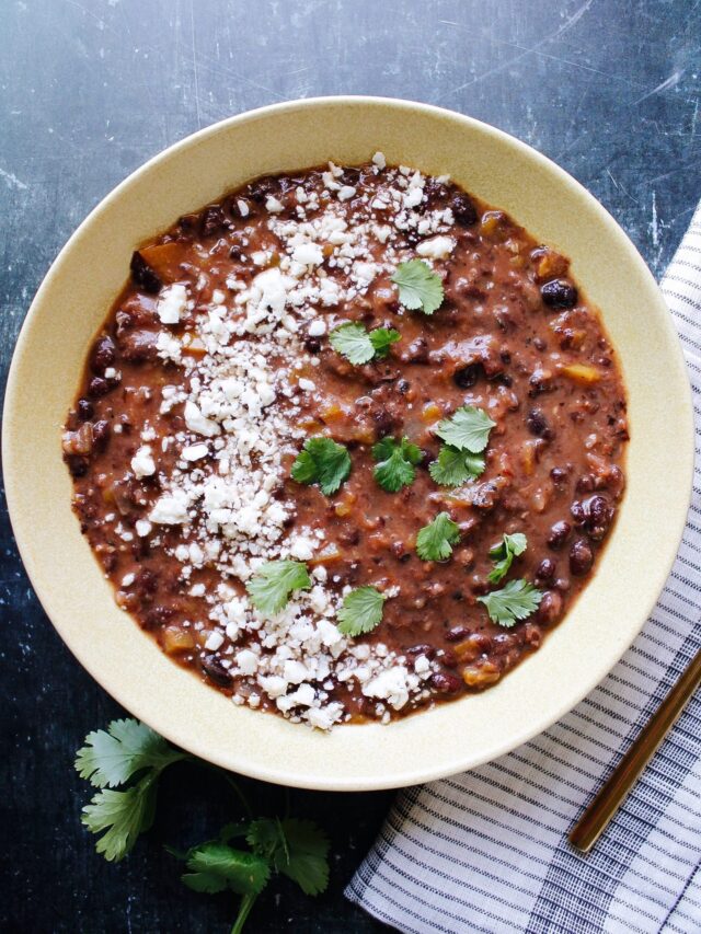 spicy black bean soup topped with cotija and cilantro