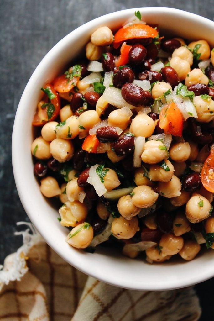 chickpea and black bean salad in a white bowl