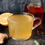 ginger mint tea with lemon in a clear glass mug