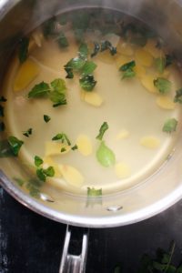 fresh ginger, mint leaves, lemon juice and water simmering in a pot