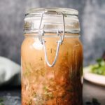 red wine shallot vinaigrette in a glass jar next to salad