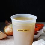 homemade chicken stock in a storage container
