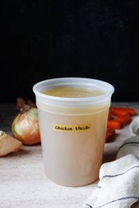 homemade chicken stock in a storage container