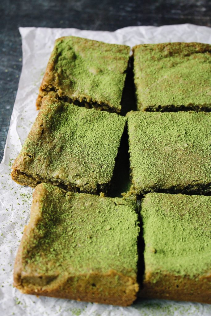 chewy matcha brownies on a piece of parchment paper
