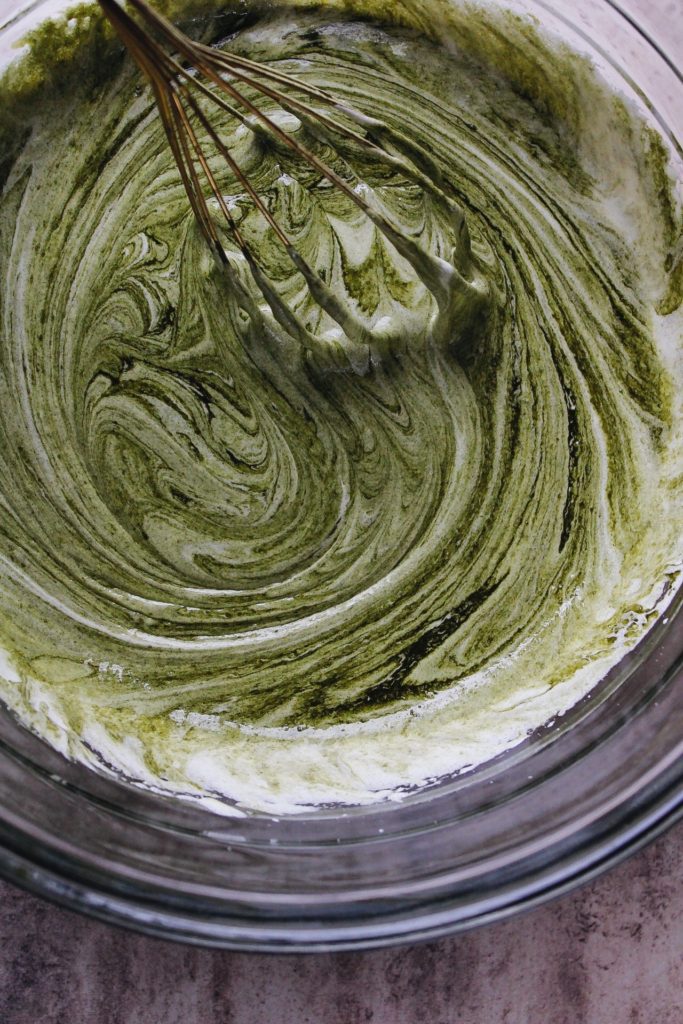 brownie mixture stirred into egg and sugar for matcha brownie recipe