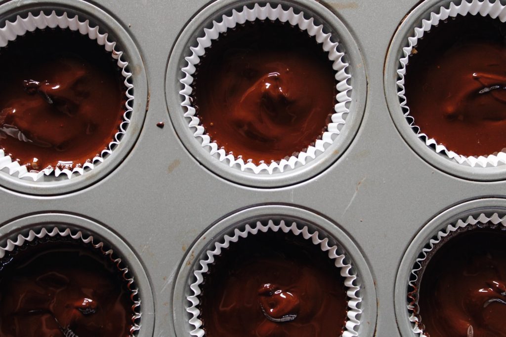 more melted chocolate added on top of sunbutter cups 