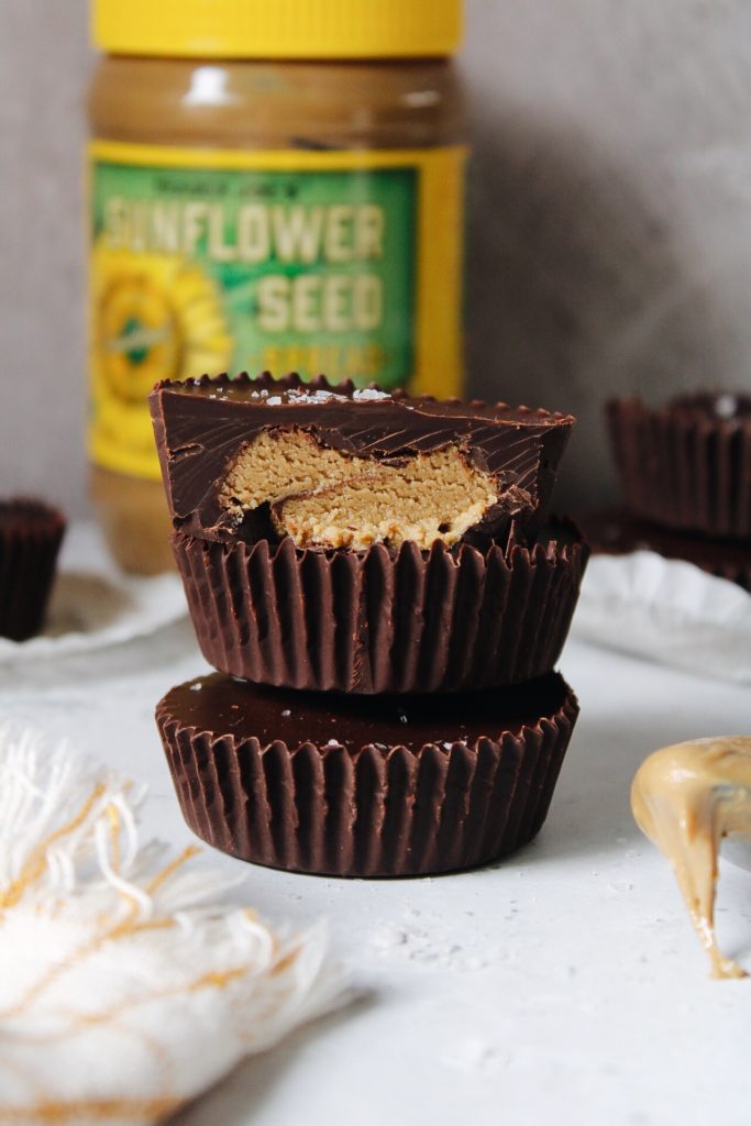 sunflower butter cups with jar of sunflower seed butter in background