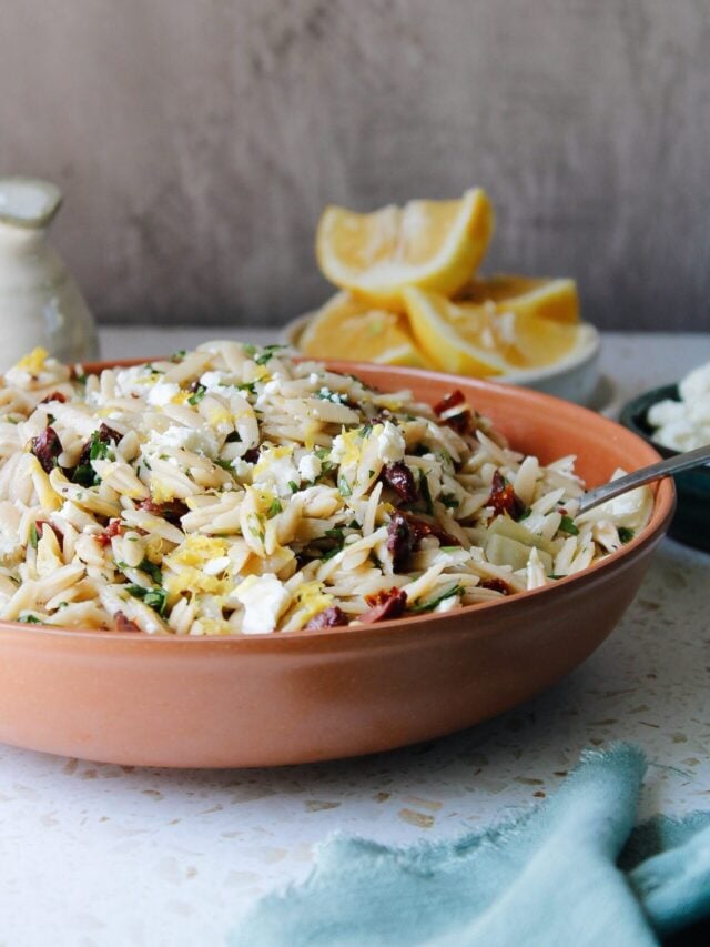 lemon orzo pasta salad in a red bowl