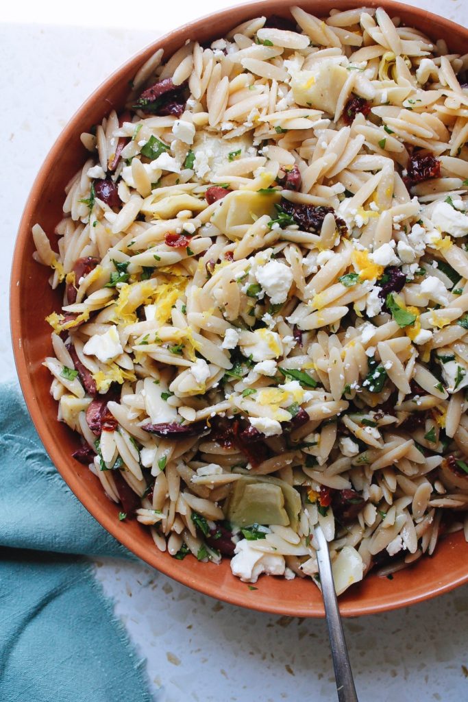 lemon orzo pasta salad in a rust colored bowl