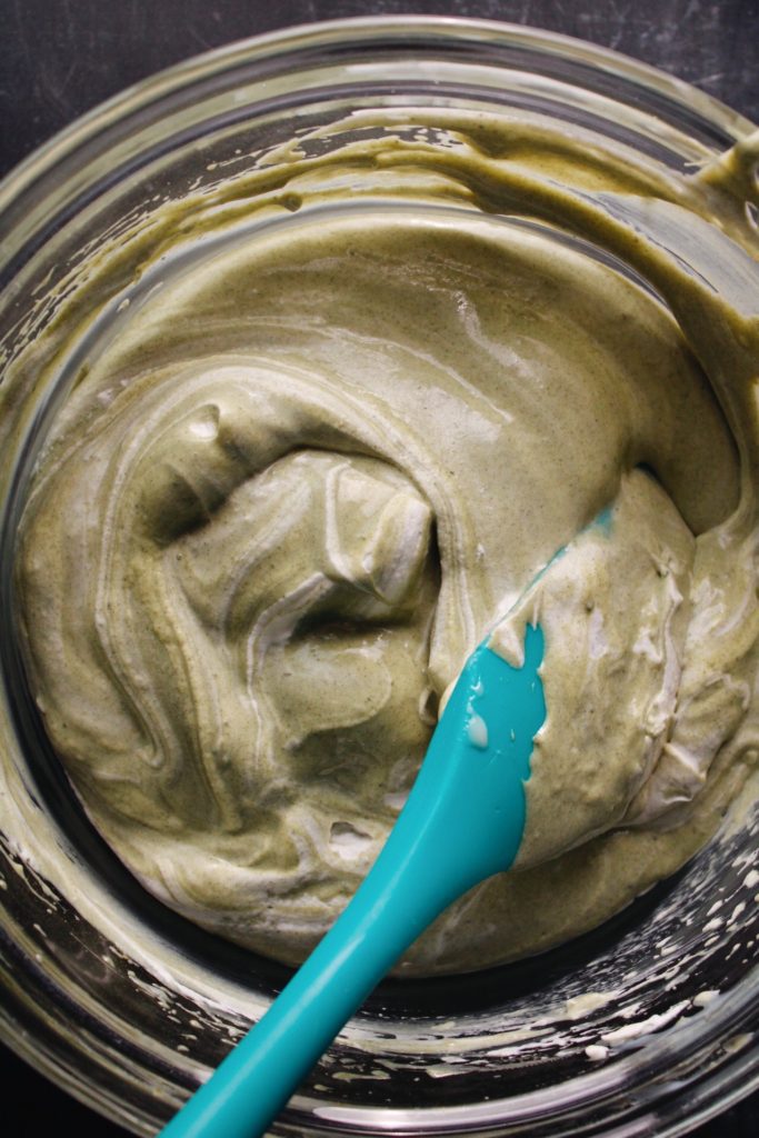 whipped cream being folded into matcha cream cheese mixture