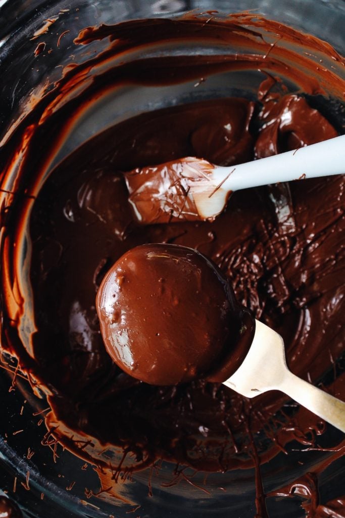 matcha cream center being dipped in melted chocolate