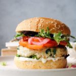 spinach and feta turkey burger on a cream colored plate