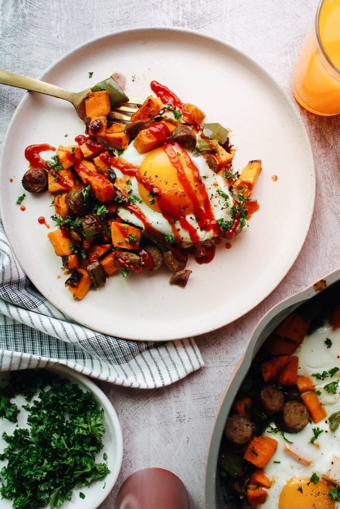 breakfast sweet potato hash topped with ketchup and hot sauce