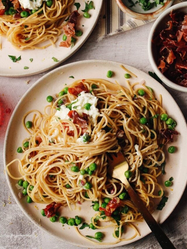 pasta with peas on a beige plate ready for consumption