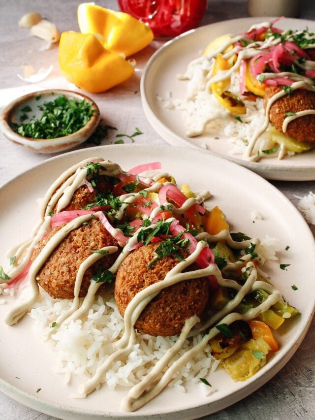 side view of trader joe's falafel on plates with veggies, rice and tahini sauce