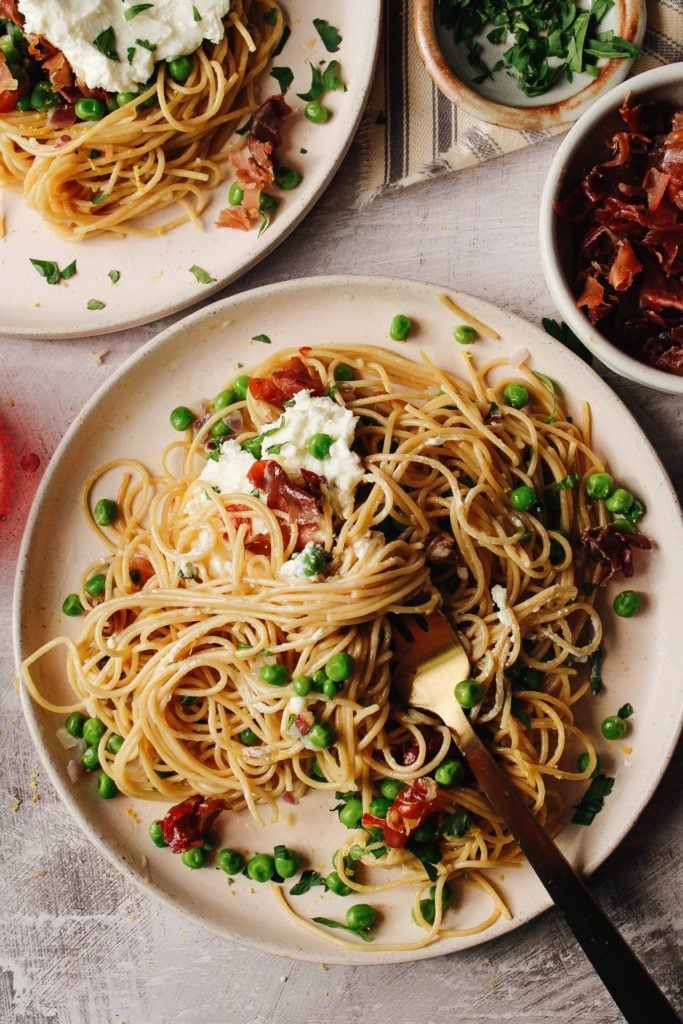 pasta with peas on a beige plate ready for consumption