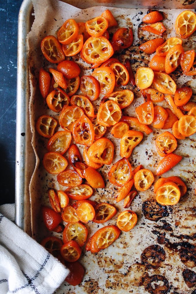 roasted kumquats on a baking sheet lined with parchment paper