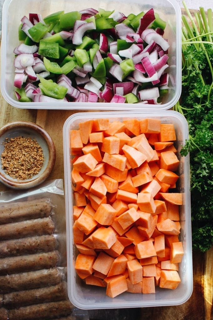 ingredients for breakfast sweet potato hash laid out on a cutting board