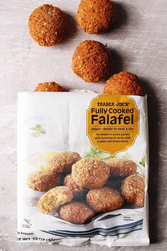 bag of trader joes frozen falafel that is cut open with some falafel coming out of the bag